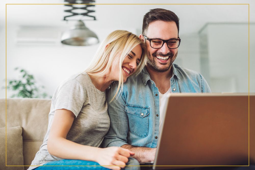 happy man and woman on laptop together